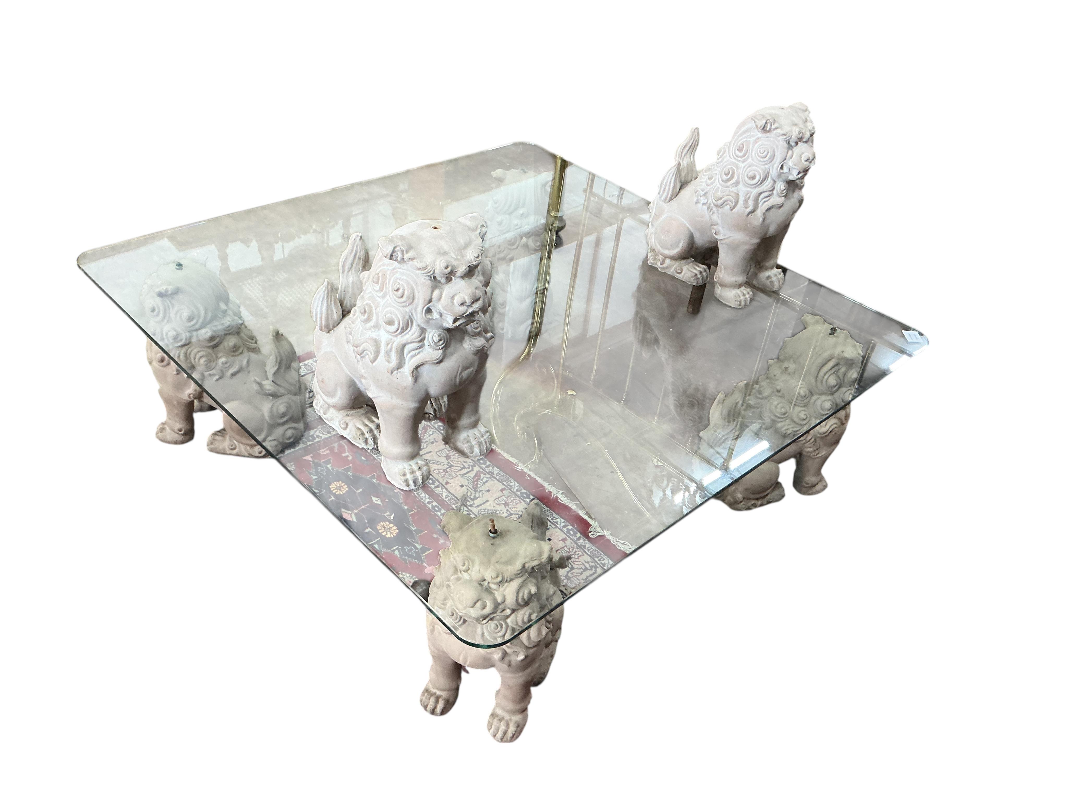 A square glass coffee table with composition shi-shi supports, 122cm, height 39cm